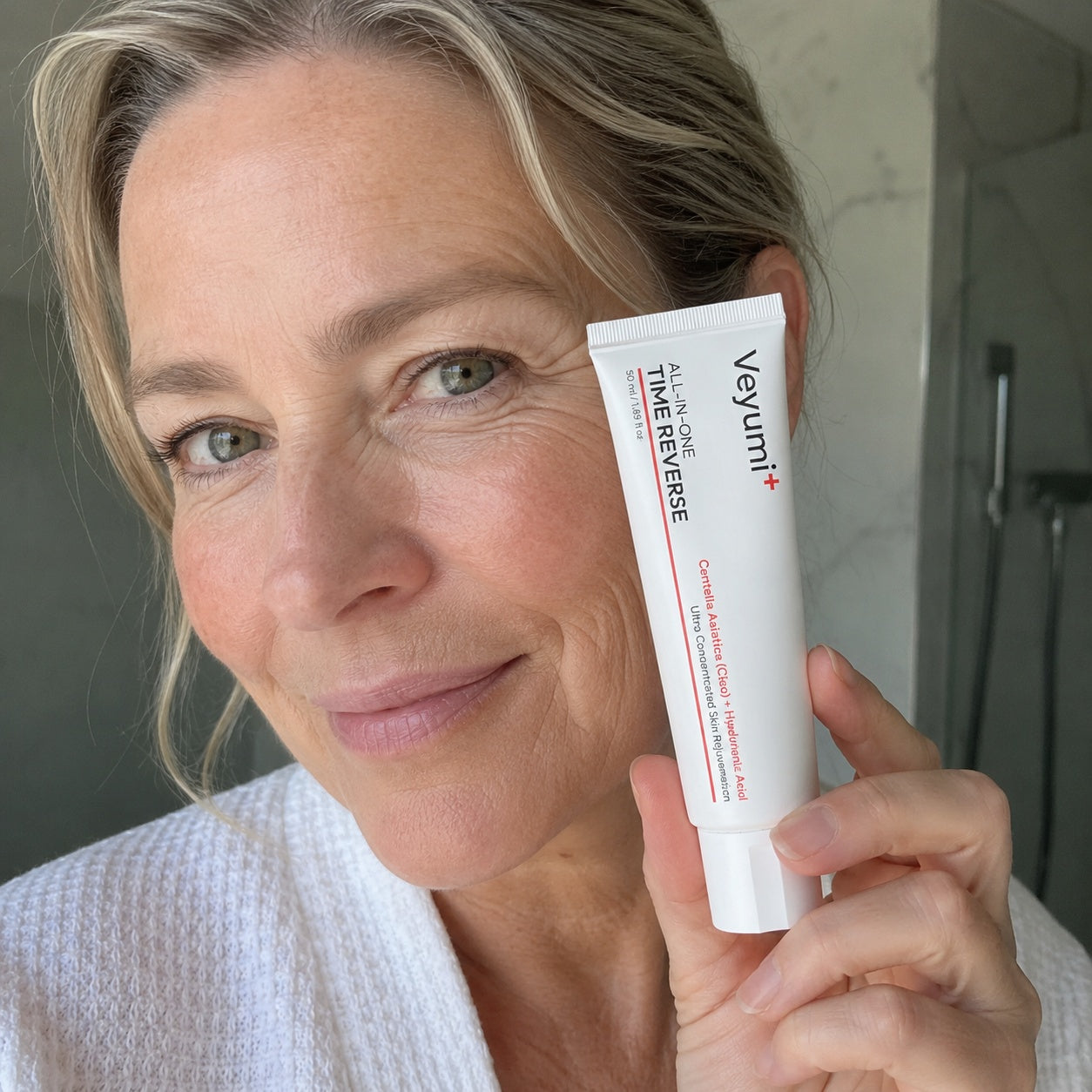 A customer in her 50s holding the Veyumi Time Reverse all-in-one cream